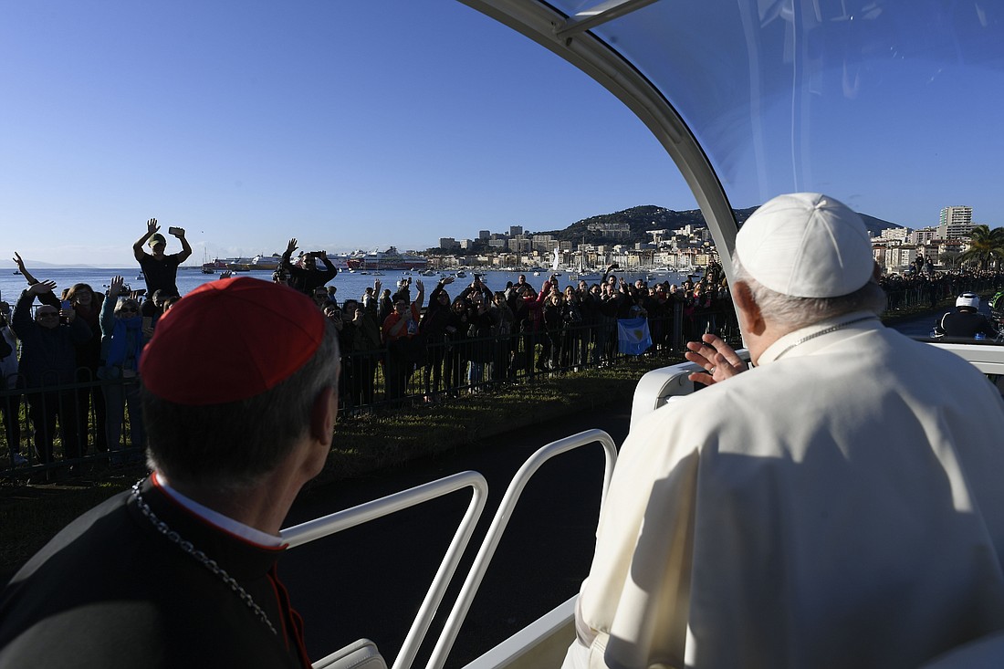 Pope Francis greets people lining the streets of Ajaccio, France, during his one-day visit to the island of Corsica Dec. 15, 2024. (CNS photo/Vatican Media)