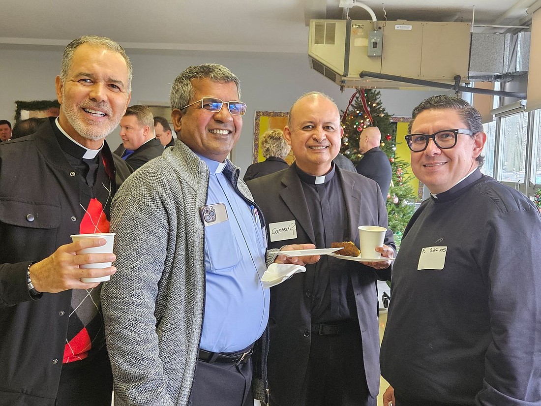 Sharing fellowship during the Advent Spirituality Day for Priests are, from left, Father Javier Diaz, pastor of Christ the King Parish, Long Branch; Father Gerald Johnson, parochial vicar of St. Joseph Parish, Toms River; Father Caesar Rubiano, chaplain in Jersey Shore Medical Center, Neptune, and parochial vicar of Holy Innocents Parish, Neptune, and Father Carlos Aguirre, pastor of Our Lady of the Angels Parish, Trenton. Mary Stadnyk photo