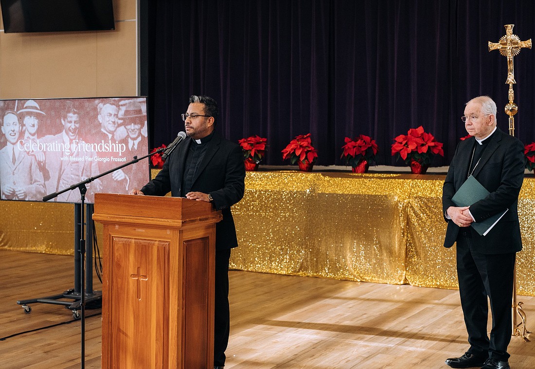 Los Angeles Archbishop José H. Gomez looks on as Father Juan Manuel Gutierrez, associate pastor at St. John the Baptist Church in Baldwin Park, Calif., speaks at a Dec. 16, 2024, press conference at his parish to share his experiences of being healed from a serious sports injury after seeking the intercession of Blessed Pier Giorgio Frassati. (OSV News photo/Isabel Cacho, courtesy Archdiocese of Los Angeles)