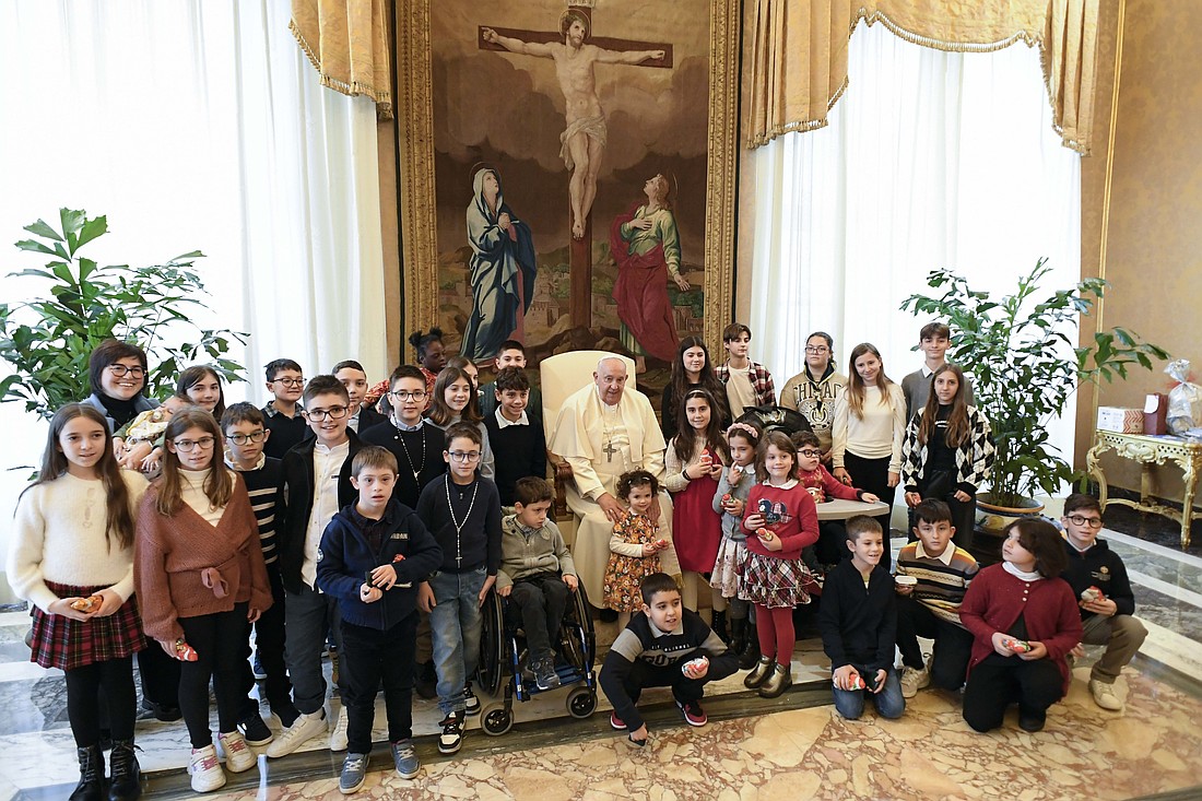 Pope Francis poses for a photo with young members of the Italian Catholic Action movement during a meeting at the Vatican Dec. 20, 2024. (CNS photo/Vatican Media)