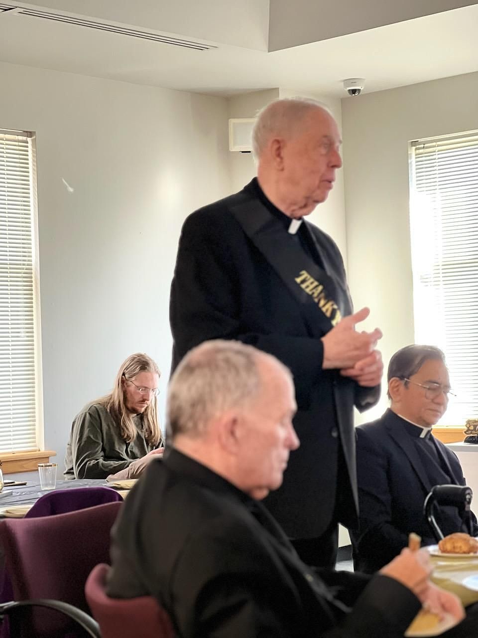 Msgr. Dermond offers comments during the celebration. On either side of Msgr. Dermond is Bishop O'Connell and Father Oscar Sumanga, current diocesan judicial vicar. Staff photos