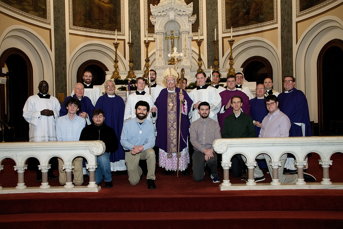 Seminarians of the Diocese pose with Bishop O'Connell and priests who concelebrated Mass Dec. 20 in Sacred Heart Church, Trenton. After the Mass Bishop O'Connell hosted a Christmas dinner in the parish rectory. Kneeling in front row are candidates who are discerning their call to priesthood. Joe Moore photo