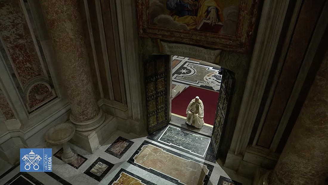 Pope Francis pauses in prayer on the threshold of the Holy Door of St. Peter's Basilica at the Vatican Dec. 24, 2024, after he opened it and inaugurated the Holy Year 2025. (CNS photo/screen grab, Vatican Media)