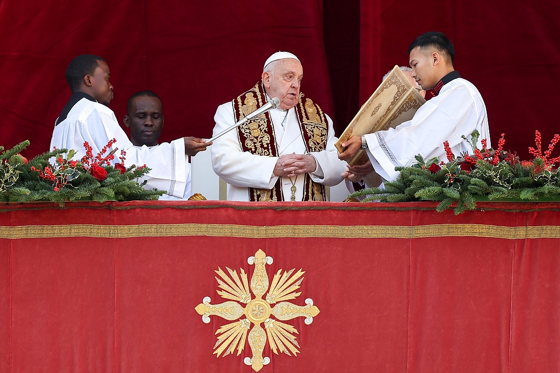 Pope Francis gives his Christmas blessing "urbi et orbi" (to the city and the world) from the central balcony of St. Peter's Basilica at the Vatican Dec. 25, 2024. (CNS photo/Lola Gomez)