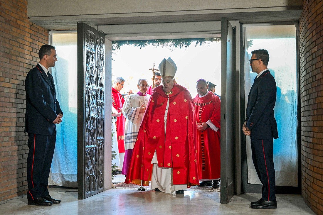 Pope Francis crosses the threshold of the Holy Door of the Church of Our Father at Rome's Rebibbia prison Dec. 26, 2024, before presiding over a Mass with inmates, prison staff and Italian government officials Dec. 26, 2024. (CNS photo/Vatican Media)