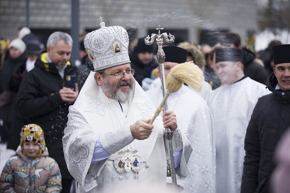 Major Archbishop Sviatoslav Shevchuk, head of the Ukrainian Greek Catholic Church, sprinkles worshippers with water during the blessing of water on the Dnipro River after he celebrated a Divine Liturgy Jan. 6, 2024, at the Patriarchal Cathedral of the Resurrection of Christ in Kyiv amid ongoing Russian agression in Ukraine. He set Ukrainian hopes high for the Jubilee Year by saying that Pope Francis accepted an invitation to visit Ukraine in 2025. The apostolic nuncio to Ukraine said nothing is "guaranteed," adding, "We will see." (OSV News photo/courtesy Ukrainian Greek Catholic Church)