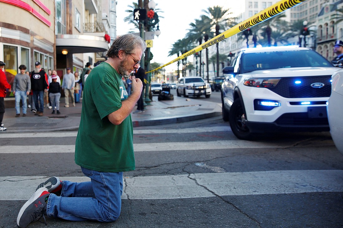 Edward Bruski crosses himself as he prays near New Orleans' French Quarter, where people were killed by a man driving a pickup truck during New Year's celebrations Jan. 1, 2025. The driver rammed the truck into a crowd, killing at least 15 people and injuring dozens of others before being shot to death by police, authorities said. (OSV News photo/Octavio Jones, Reuters)