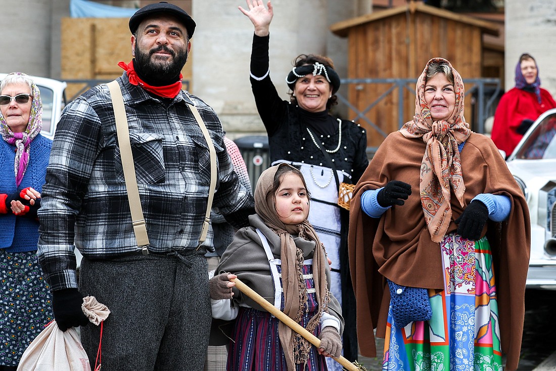 People dressed in traditional Italian costumes celebrate in St. Peter’s Square during Pope Francis’ Angelus on the feast of the Epiphany at the Vatican Jan. 6, 2025. (CNS photo/Lola Gomez)