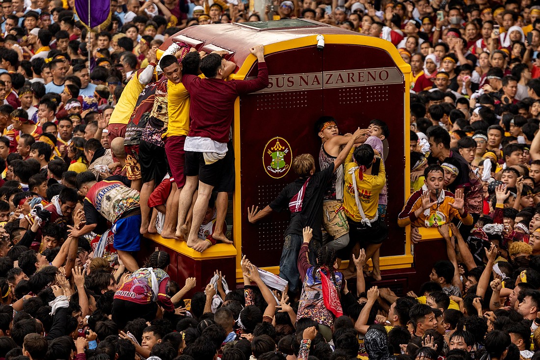 Filipino Catholics jostle to touch the carriage carrying the statue of the Black Nazarene during the annual procession on its feast day in Manila Jan. 9, 2025. The wooden statue, carved in Mexico and brought to the Philippine capital early in the 17th century, is cherished by Catholics, who believe that touching it can lead to a miracle. (OSV News photo/Eloisa Lopez, Reuters)