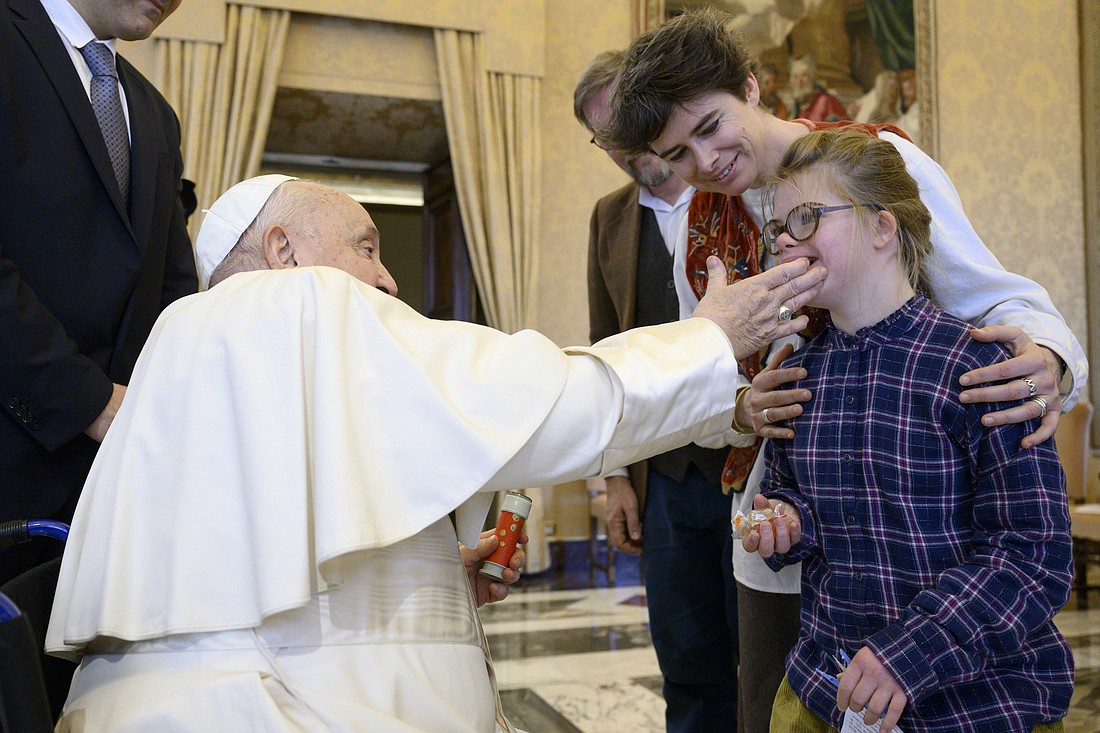 Pope Francis greets a young girl during a meeting with the leaders of the French "Mission Congress" project, which organizes annual gatherings for Christians, at the Vatican Jan. 10, 2025. (CNS photo/Vatican Media)