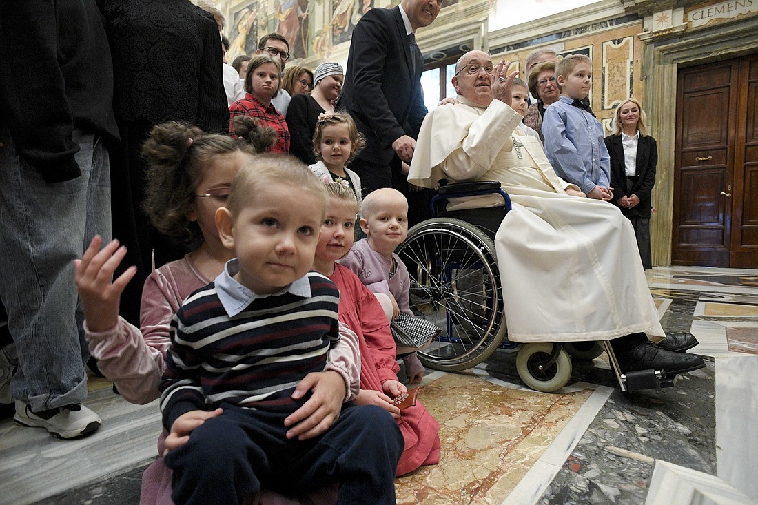 Pope Francis waves during an audience at the Vatican Jan. 10, 2025, with young people receiving care at an oncology-hematology clinic in Poland, their families, medical staff and the organizers of the group's pilgrimage to Rome from Wroclaw. (CNS photo/Vatican Media)