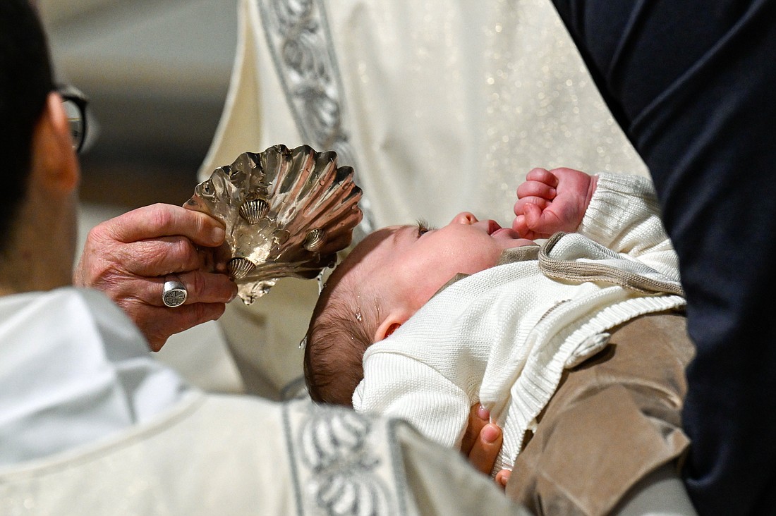 Pope Francis baptizes a baby during Mass in the Sistine Chapel at the Vatican Jan. 12, 2025, the feast of the Baptism of the Lord. (CNS photo/Vatican Media)