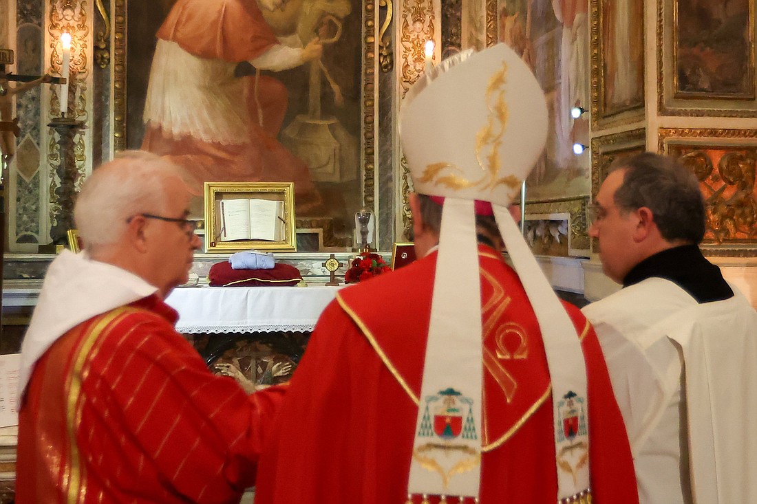 Archbishop Fabio Fabene, secretary of the Dicastery for the Causes of Saints, blesses the relics of U.S. Notre Dame de Namur Sister Dorothy Stang, including a sweater and a cross containing blood-soaked dirt, as they are placed on an altar at the shrine of new martyrs at the Basilica of St. Bartholomew on Tiber Island in Rome Jan. 10, 2025. Sister Stang was killed in the Amazon in 2005. (CNS photo/Lola Gomez)