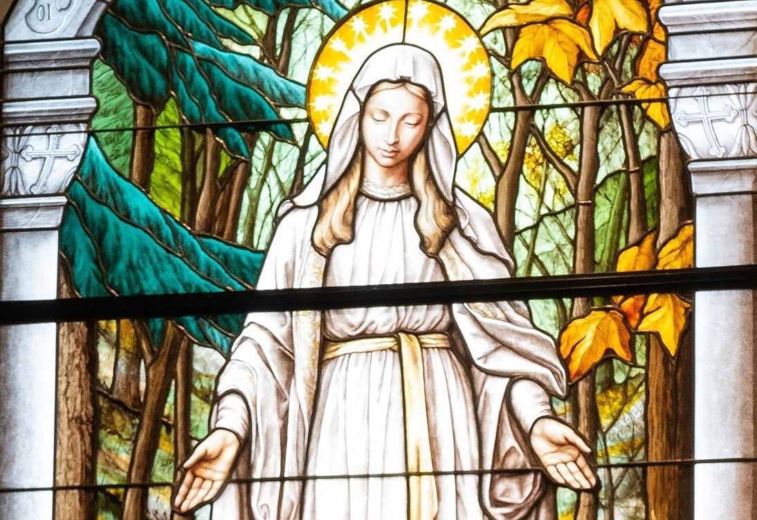 A stained-glass window at the National Shrine of Our Lady of Champion in Champion, Wis., depicts the Blessed Virgin Mary appearing to Adele Brise. Several Catholics who have fled the wildfires ravaging Los Angeles have been praying for the intercession of Our Lady of Champion, who once saved a rural Wisconsin shrine from a devastating inferno. (OSV News photo/Sam Lucero)