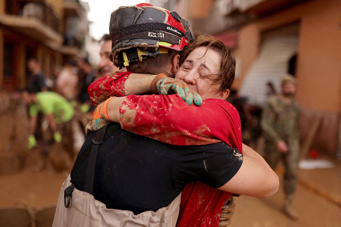 A member of Spain's Military Emergency Unit embraces with a local woman in Sedavi, Spain, Nov. 3, 2024, following heavy rains that caused massive flooding. While we can't stop every bad thing from happening, we can become more merciful in our response to people in need, writes Lorene Hanley Duquin. (OSV News photo/Nacho Doce, Reuters)