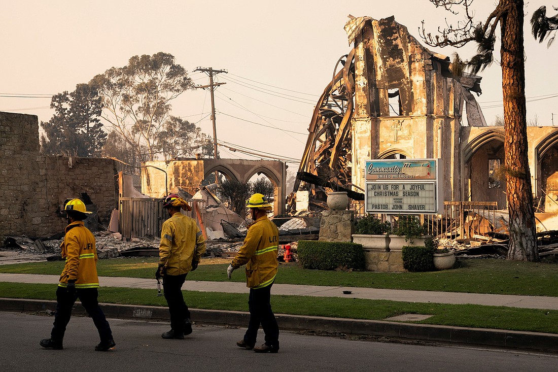 Firefighters walk near a destroyed Methodist church Jan. 10, 2025, following the Palisades Fire in Los Angeles. As of late Jan. 14, the death toll numbered at least 25 people, but with several wildfires raging, officials warn the actual toll will remain unclear until it's safe for investigators to access neighborhoods. Tens of thousands of people have been impacted by evacuation orders since the blazes began Jan. 7. (OSV News photo//David Ryder, Reuters)