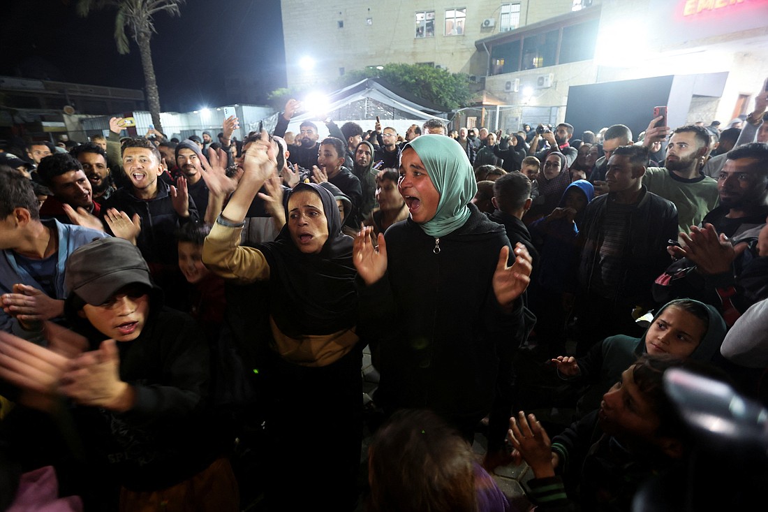 Palestinians in Deir Al-Balah, in the central Gaza Strip, react to news on a Hamas ceasefire deal with Israel Jan. 15, 2025. (OSV News photo/Ramadan Abed, Reuters)