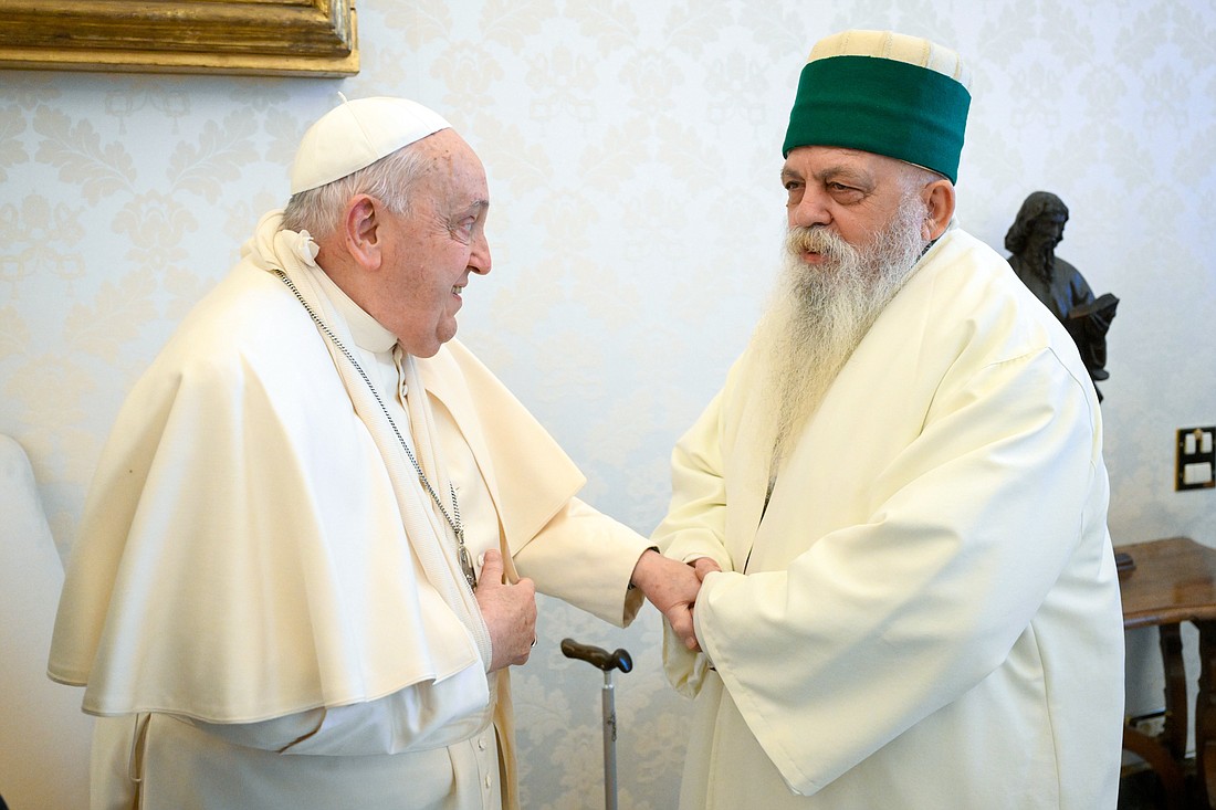 Pope Francis, wearing a sling on his right arm after a fall, uses his left hand to greet Edmond Brahimaj, leader of the Bektashi community of Muslim Sufis from Tirana, Albania, at the Vatican Jan. 16, 2025. The Vatican said the pope injured his arm in a fall and while nothing was broken, the arm was immobilized as “a cautionary measure.” (CNS photo/Vatican Media)