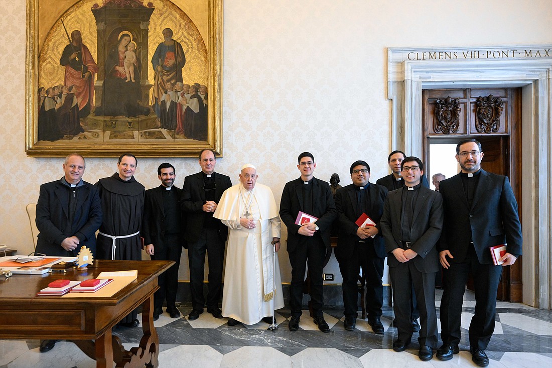 Pope Francis poses for a photo with Argentine priests living in Rome during a meeting at the Vatican Jan. 16, 2025. Earlier in the day, the pope fell and hurt his right arm; while nothing was broken, he is wearing a sling as a "precautionary measure," the Vatican said. (CNS photo/Vatican Media)