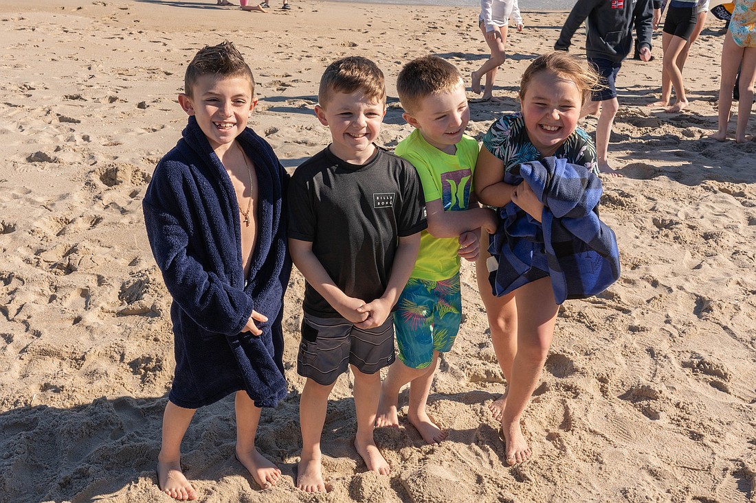 Student "plungers" from St. Mary School, Middletown, huddle after their dip in the ocean for the 2024 Polar Plunge in Sea Bright. Courtesy photo