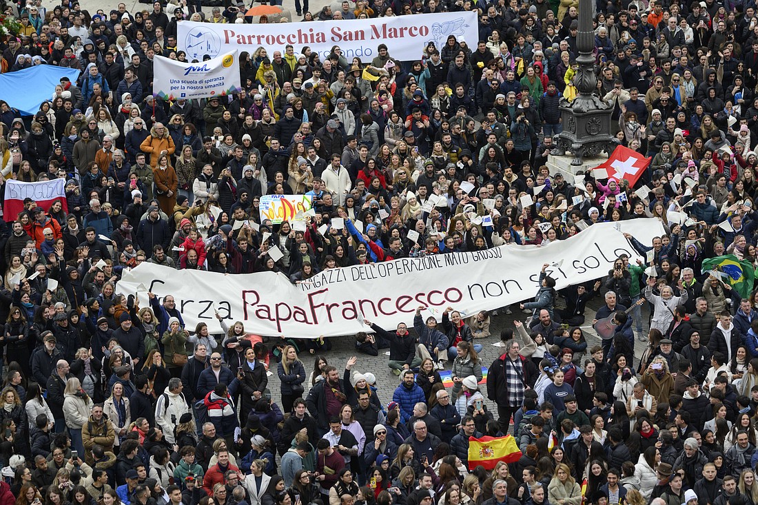 A group of people hold a banner urging Pope Francis to be strong, "you are not alone," as they greet him during the Angelus prayer in St. Peter's Square at the Vatican Jan. 19, 2025. (CNS photo/Vatican Media)