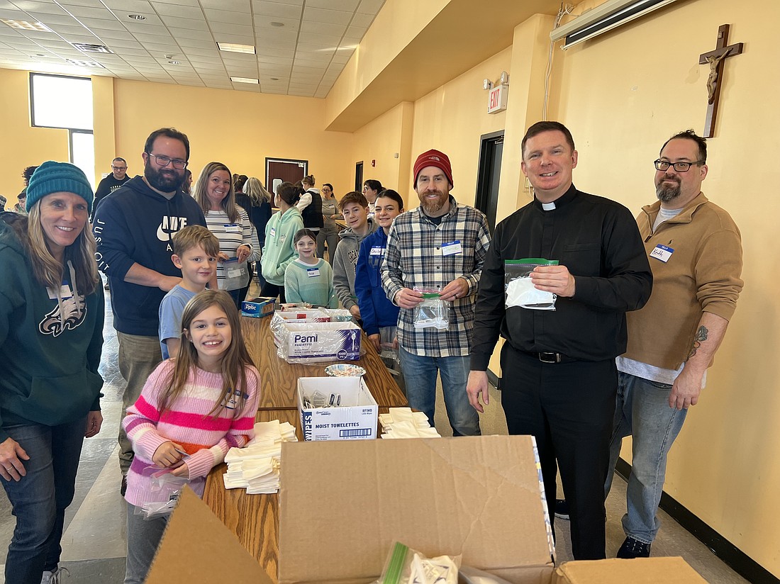 Father Michael McClane, pastor of Holy Eucharist Parish, Tabernacle, and families spent part of their observance of Martin Luther King Day doing an act of service  in which they assisted Cathedral Kitchen, an emergency food provider in Camden. The Holy Eucharist parishioners assembled utensil packets, decorated placemats, assembled centerpieces and collected fruit and snacks. Elizabeth Zimak photo