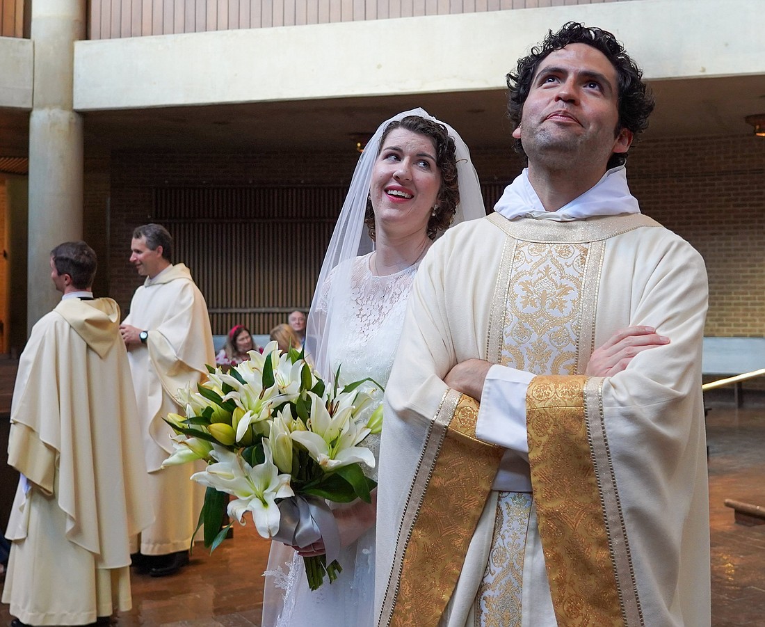 Following the Mass at the Church of the Incarnation on the campus of the University of Dallas June 22, 2024, for her consecration to the "Ordo Virginum," the Order of Virgins, Karen Bless shares a light-hearted moment with Dominican Father Thomas More Barba, former rector of the church. (OSV News photo/Michael Gresham, The Texas Catholic)