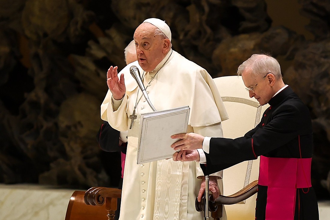 Pope Francis gives his blessing to visitors in the Paul VI Audience Hall at the Vatican at the end of his weekly general audience Jan. 22, 2025. (CNS photo/Lola Gomez)