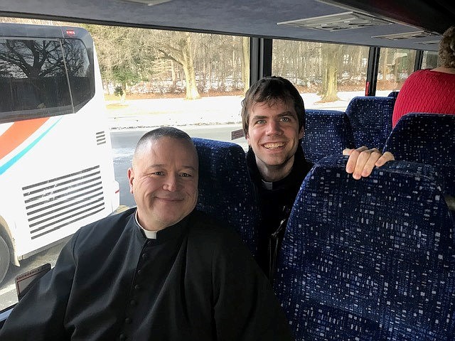 Father Michael Wallack, pastor of St. John the Baptist Parish in Allentown, and Father Wynne Kerridge, parochial vicar of St. James Parish in Red Bank, board a bus for the 52nd annual March for Life. (Courtesy photo)