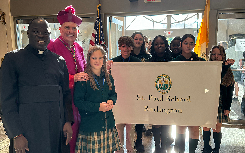 Bishop O’Connell and Father Jean Felicien, who serves as secretary and master of ceremonies to Bishop O'Connell, join students from St. Paul School, Burlington, prior to the start of the annual Catholic Schools Mass, October 10.  Marianne Hartman photo.