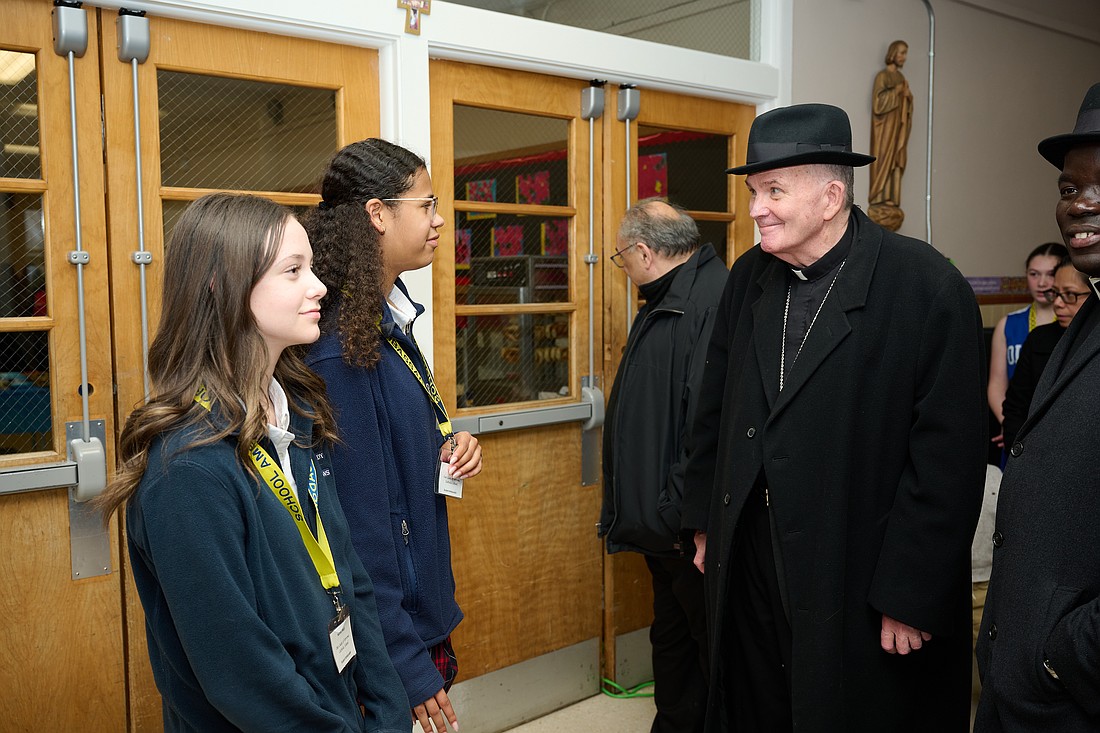 Students from Our Lady of Sorrows School, Hamilton, greet Bishop O'Connell during his Jan. 26 visit. Mike Ehrmann photo