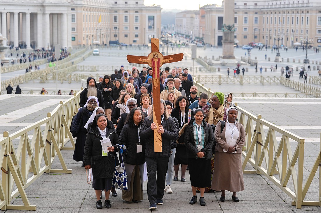 Pilgrims make their way through St. Peter's Square toward the Holy Door of St. Peter's Basilica during the Jubilee of the World of Communications at the Vatican Jan. 25, 2025. (CNS photo/Lola Gomez)