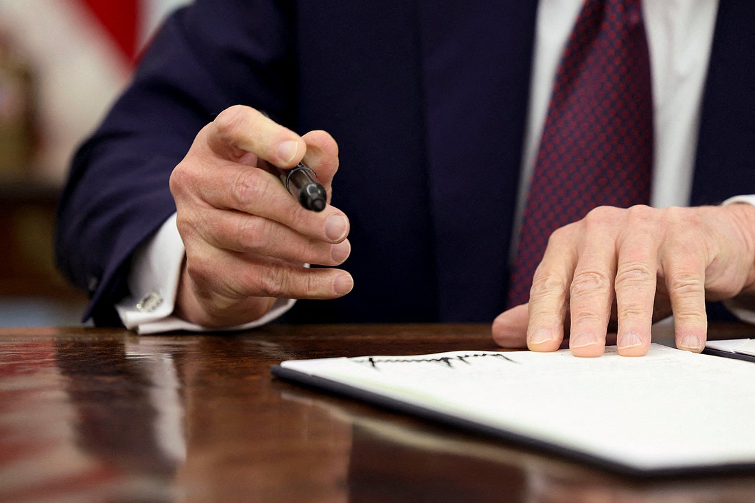 U.S. President Donald Trump signs an executive order in the Oval Office of the White House, in Washington, Jan. 23, 2025. On Jan. 24, Trump reinstated a global health assistance policy, commonly referred to as the Mexico City Policy, barring taxpayer funds from going to nongovernmental organizations abroad that perform abortions. He also signed an executive order to further enforce a ban on federal funding for abortion known as the Hyde Amendment. (OSV News photo/Kevin Lamarque, Reuters)