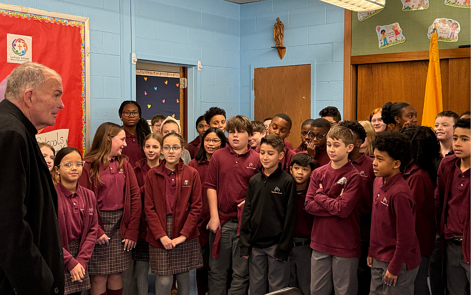 Bishop O'Connell speaks with students in the sixth grade following his tour of the Lawrenceville school.