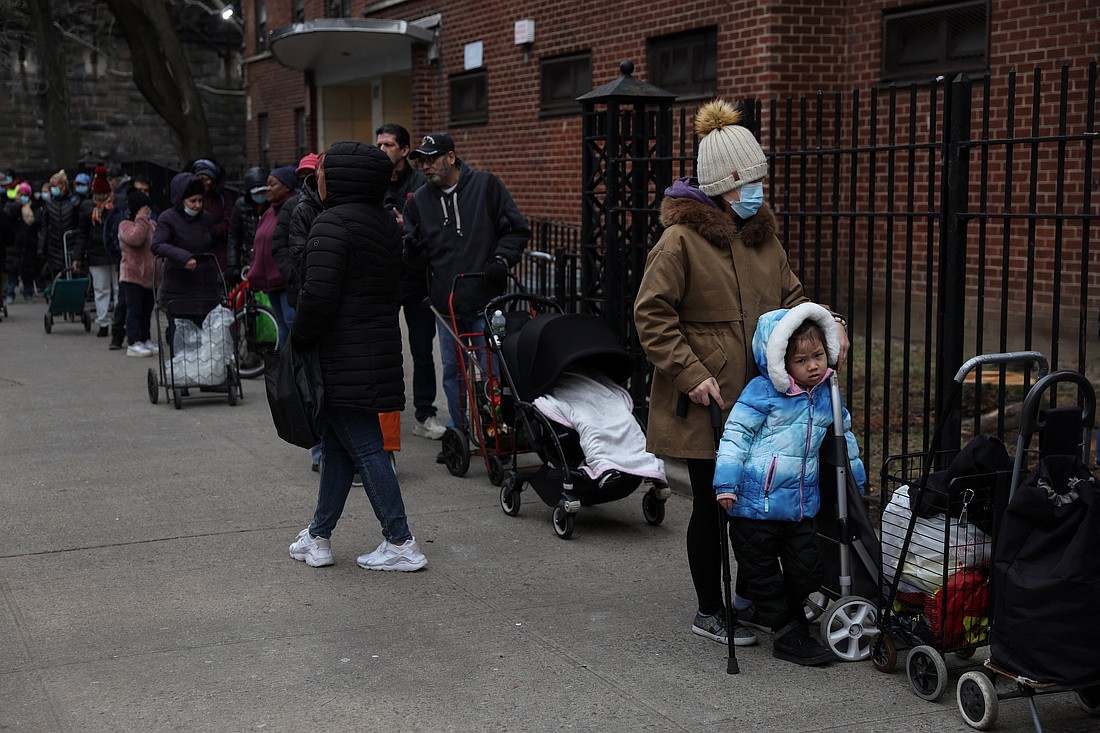 People wait in line to receive food donations from Catholic Charities services along 105th street in the East Harlem area of New York City, Feb. 22, 2023. (OSV News photo/Shannon Stapleton, Reuters)