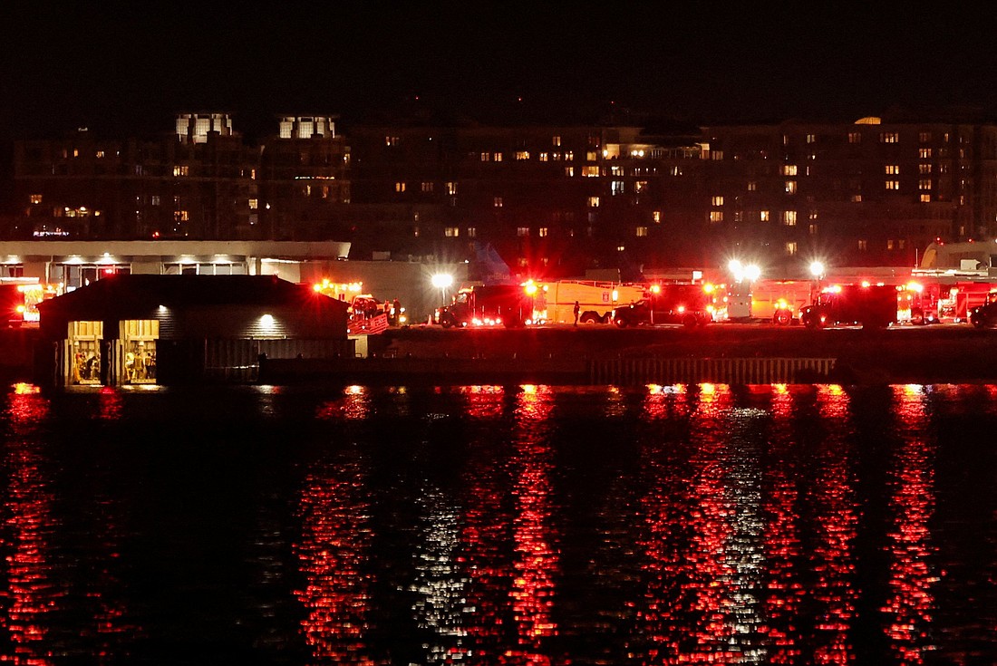 Emergency service vehicles are on the scene after American Eagle flight 5342 collided with a Blackhawk helicopter while approaching Ronald Reagan Washington National Airport and crashed in the Potomac River Jan. 29, 2025. The flight was inbound to Reagan National Airport at an altitude of about 400 feet and a speed of about 140 miles per hour when it suffered a rapid loss of altitude. The Canadian-made Bombardier CRJ-701 twin-engine jet was manufactured in 2004 and can be configured to carry up to 70 passengers. (OSV News photo/Carlos Barria, Reuters)