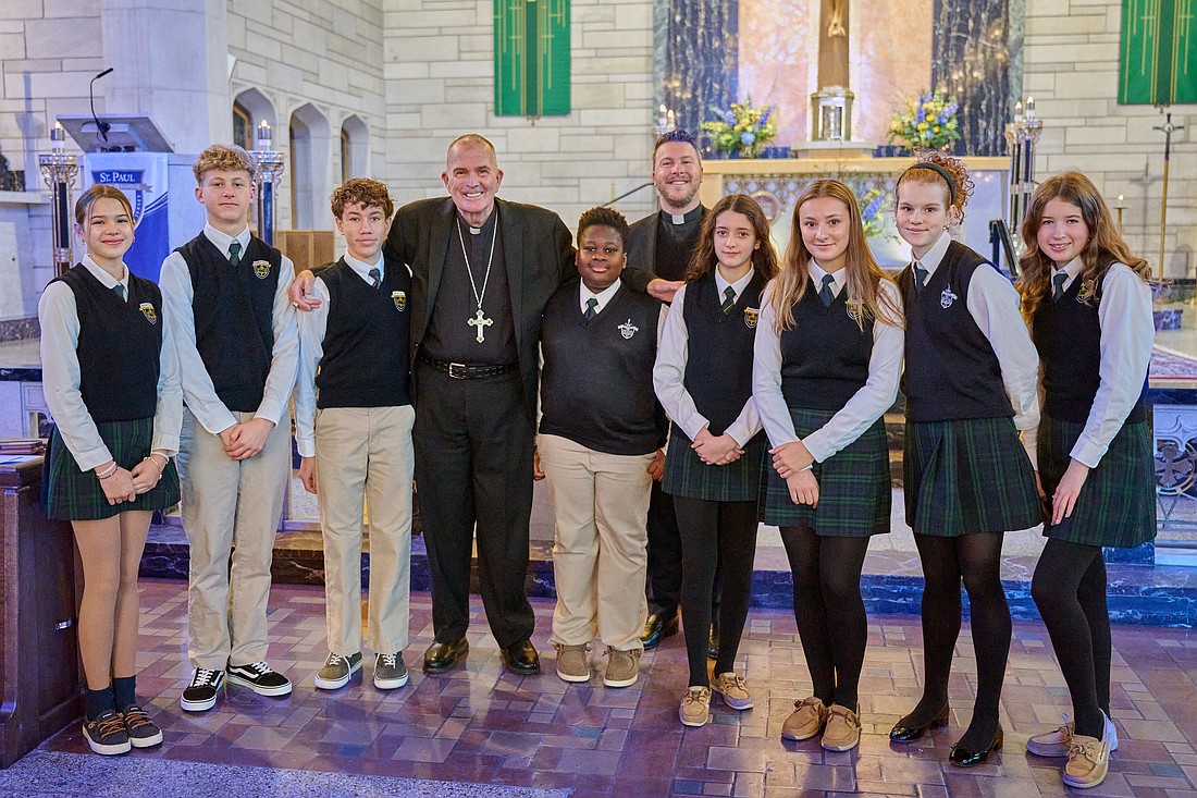 Bishop David M. O'Connell, C.M., joins St. Paul School students and Father Christopher Dayton, pastor, St. Paul Parish, Princeton, for a photo during Catholic Schools Week. Bishop O'Connell serves as chairman of the U.S. Conference of Catholic Bishops’ Committee on Catholic Education. Mike Ehrmann photo