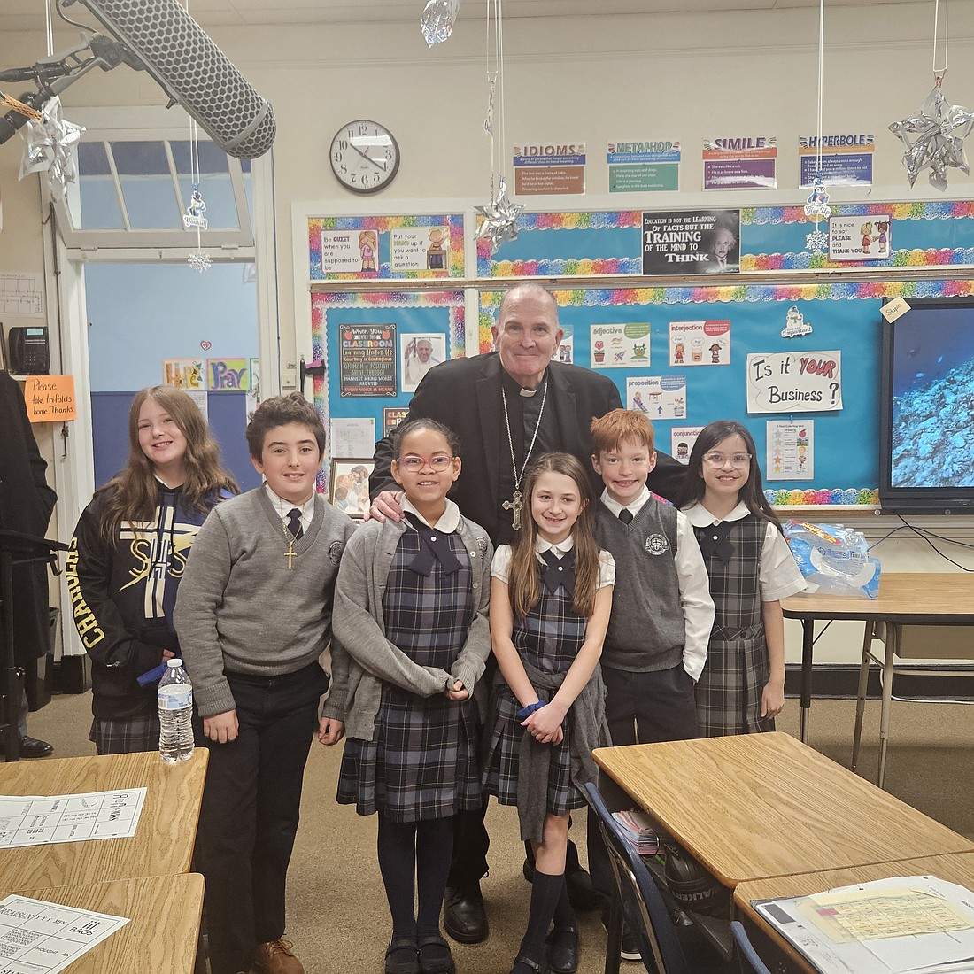 Bishop O'Connell poses for a photo with students during a visit to a classroom in Sacred Heart School. Mary Stadnyk photo