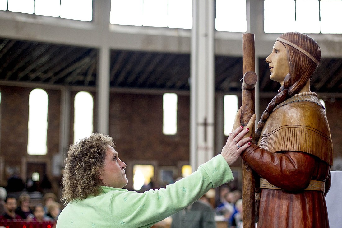 Deborah Amell touches a statue of St. Kateri Tekakwitha in 2012 at Our Lady of the Martyrs Shrine in Auriesville, New York, the site of a 17th century Mohawk village where three Jesuit missionaries were killed for their faith in and St. Kateri was born. The U.S. Conference of Catholic Bishops designated the site a national shrine Jan. 27, 2025. (OSV News photo/Jason Greene, Reuters)