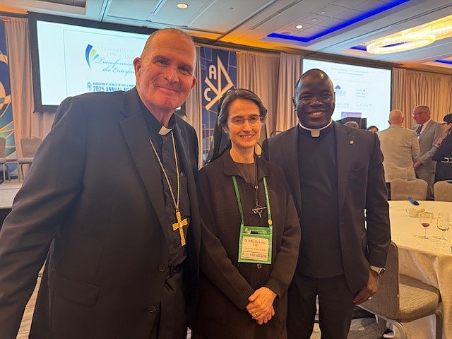 Bishop O'Connell, left, and Father Jean Felicien, the Bishop's priest-secretary and master of ceremonies, pose for a photo with Sister Raffaella Petrini, FSE, who serves as Secretary General of the Vatican City State during the Annual meeting of the Association of Catholic Colleges and Universities in Washington. Staff photo