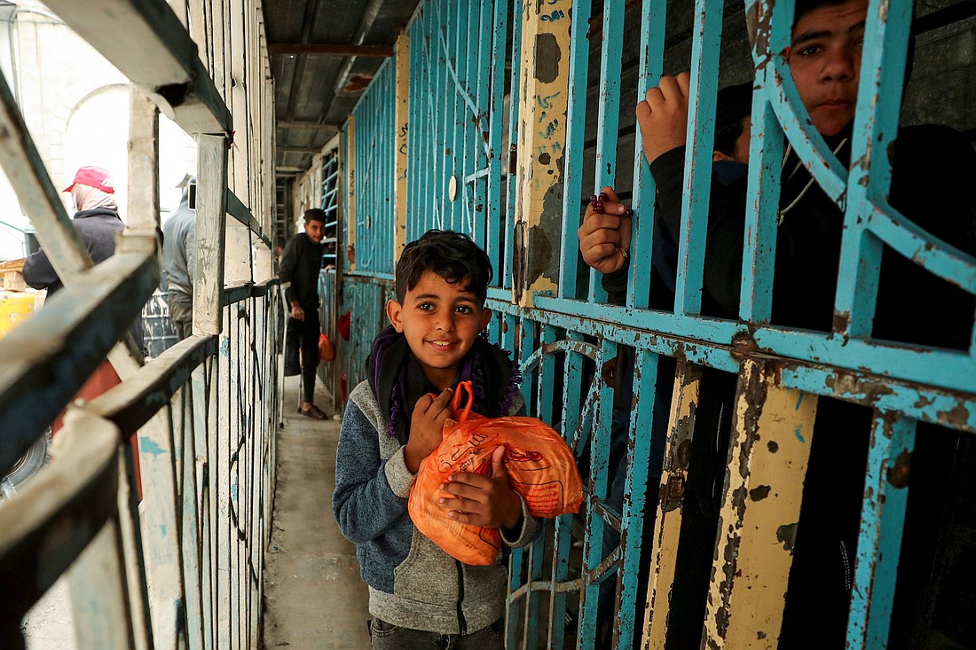 A Palestinian boy carries a plastic bag with bread Feb. 3, 2025, in Gaza City in Gaza Strip amid a ceasefire between Hamas and Israel. (OSV News photo/Dawoud Abu Alkas,  Reuters)