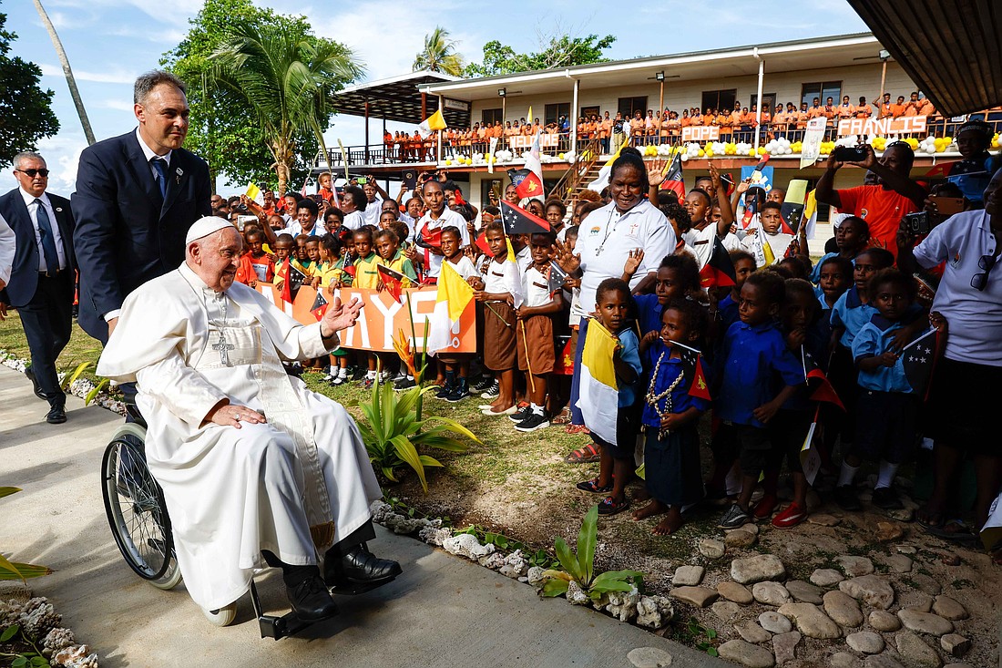 Pope Francis is welcomed by children and missionaries at the Queen of Paradise School and Hall in Baro, Papua New Guinea, Sept. 8, 2024. (CNS photo/Lola Gomez)