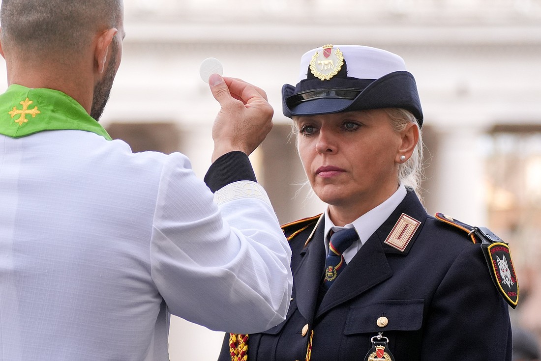 A member of the Albanian state police receives Communion during Mass celebrated by Pope Francis for the Jubilee of the Armed Services, Police and Security Personnel in St. Peter’s Square at the Vatican Feb. 9, 2025. (CNS photo/Lola Gomez)