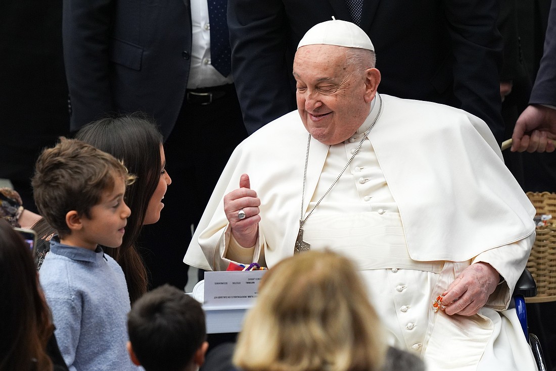 Pope Francis greets children at the conclusion of his general audience in the Paul VI Audience Hall at the Vatican Feb. 12, 2025. (CNS photo/Lola Gomez)