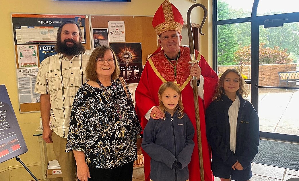 Members of the Torpila family pose for a photo with Bishop David M. O’Connell, C.M., during a visit he made to the parish in September. Courtesy photo