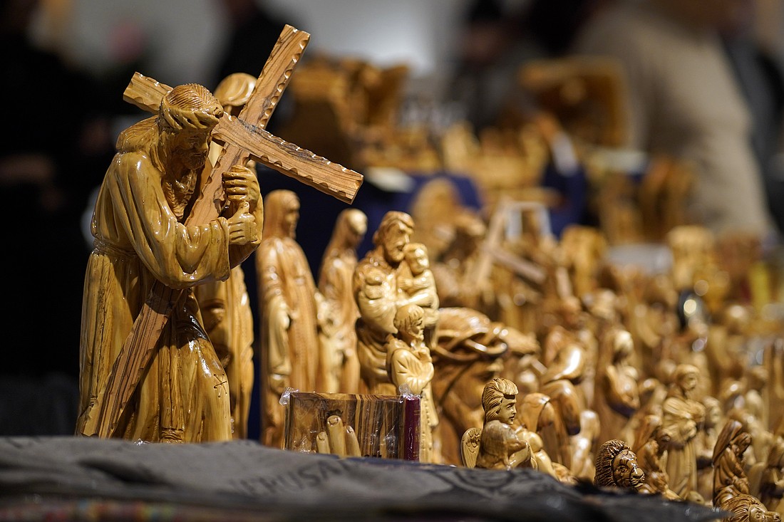 Olive wood carvings created by artisans based in and around Bethlehem, West Bank, are displayed on the table of the nonprofit Land of Peace on the opening night of the New York Encounter in New York City Feb. 14, 2025. Encounter is an annual three-day cultural festival featuring presentations, panel discussions, historical exhibits and music. The event is organized by the worldwide Catholic lay ecclesial movement Communion and Liberation. (OSV News photo/Gregory A. Shemitz)