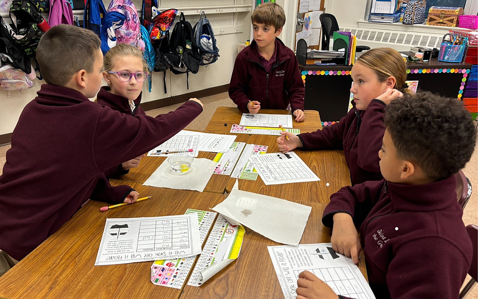 Students from St. Leo the Great School, Lincroft, conduct an experiment in Science class. Facebook photo