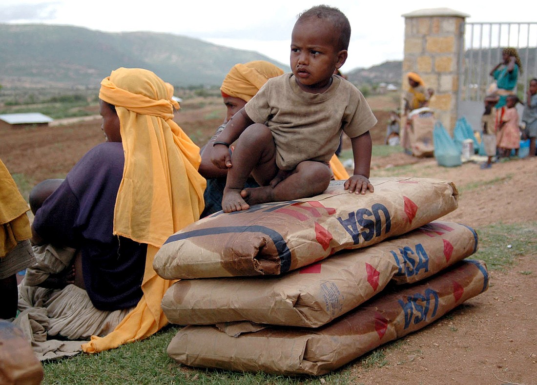 A malnourished Ethiopian boy is pictured in a file photo siting on sacks of food donated by USAID at a food distribution center near Harar, in eastern Ethiopia. As the United States paused foreign assistance to countries across the world in January 2025, confusion, panic and desperation has gripped many organizations that benefit from the funds, including church-based groups. (OSV News photo/Andrew Heavens, Reuters)