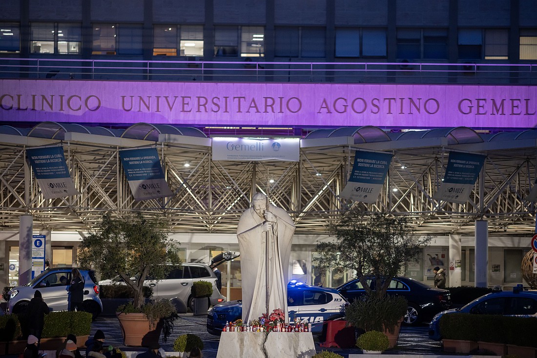 A statue of St. John Paul II stands outside Rome's Gemelli hospital Feb. 19, 2025, where Pope Francis is being treated for double pneumonia. (CNS photo/Pablo Esparza)