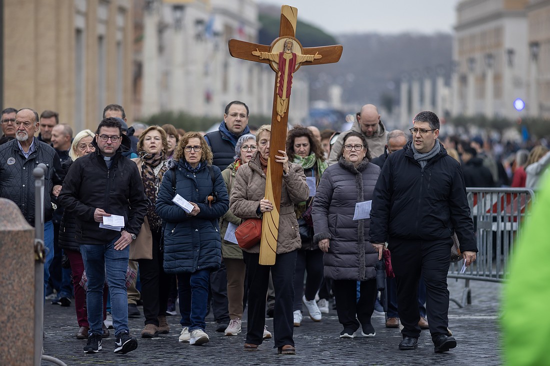 Pilgrims walk toward the Holy Door of St. Peter's Basilica at the Vatican Feb. 19, 2025, while Pope Francis is hospitalized at Rome's Gemelli hospital. (CNS photo/Pablo Esparza)